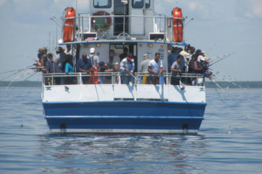 Picture of people fishing off of the boat