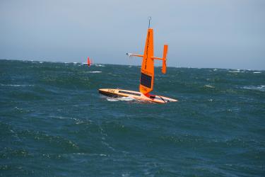 Photo of two saildrones in open water.