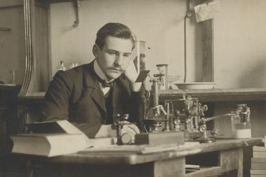 Paul Galtsoff early in his career sitting at a desk in a lab in Russia