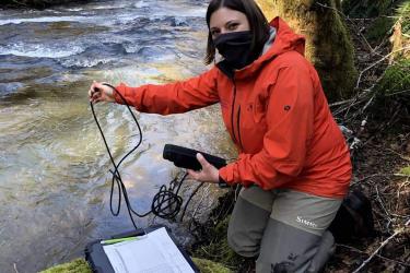 Woman conducting water monitoring samples, turbidity, depth, and temperature  on multiple creeks that flow into the Columbia River