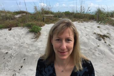 A headshot of Tauna Rankin standing on the beach Florida