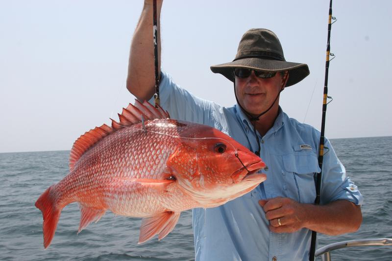 Recreational fisherman with red snapper. 