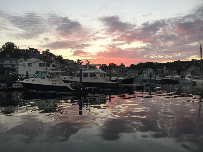 Boats in a harbor at sunrise