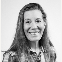 Smiling Heidi Marotta in plaid shirt. 