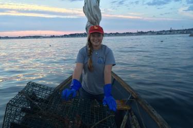 Samantha Tolken working on the water with lobster traps.