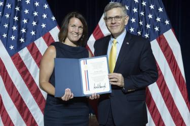 Scientist accepting distinguished award from government